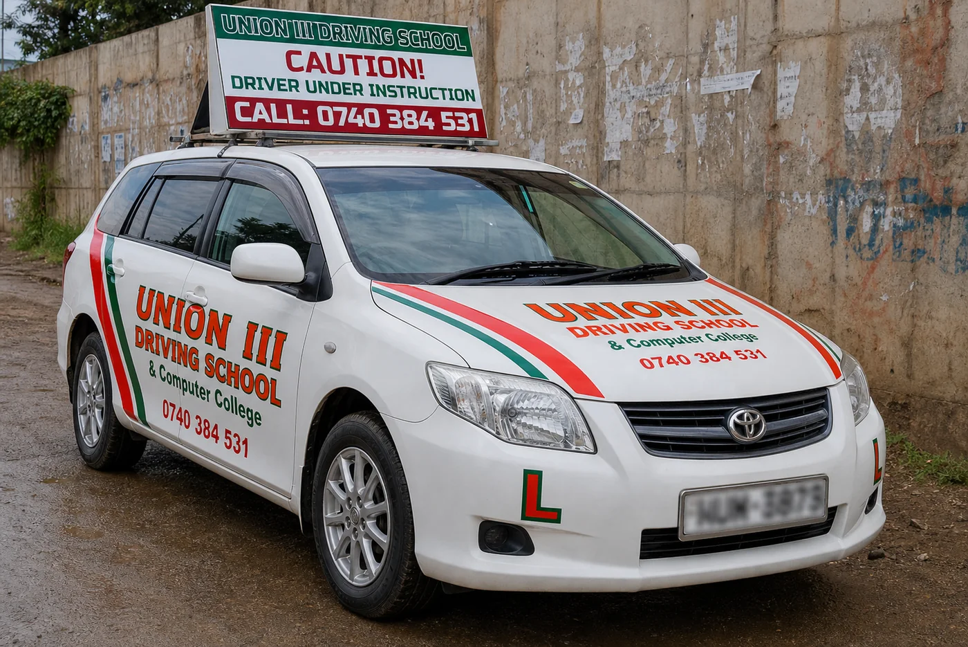Union III branded light vehicle training car with large caution roof banner and blurred number plate