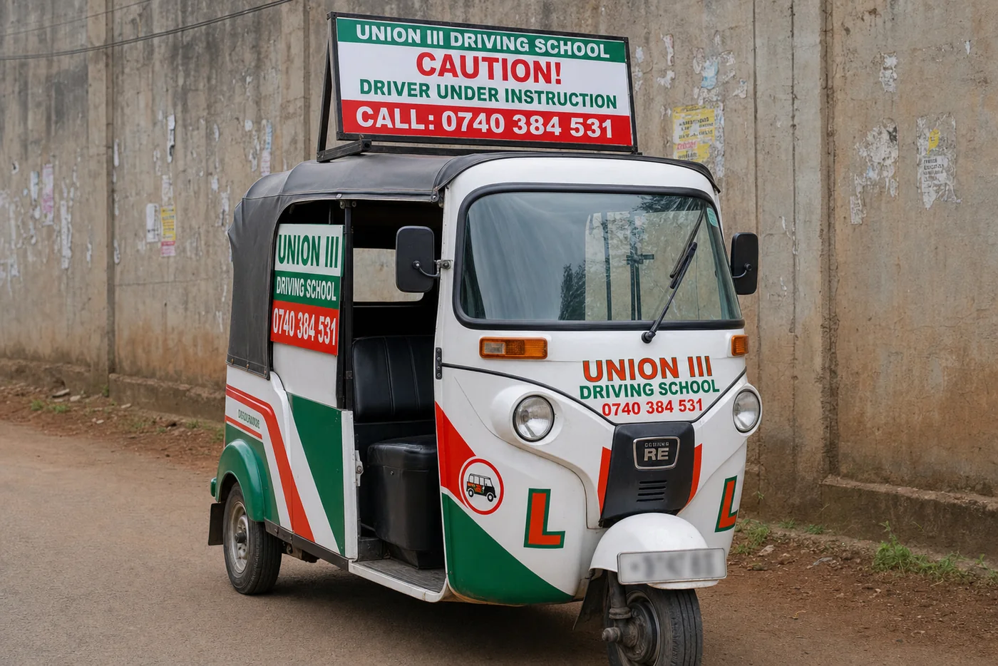 Union III branded tuk tuk training vehicle with large caution roof banner and blurred number plate